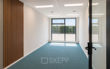 Lichte kantoorruimte met glazen deur en groot raam in kantoorpand aan Veluwezoom 15, Almere Stad. Ideaal voor wie kantoorruimte wil huren. Ontvang daglicht en uitzicht op buitenruimte.