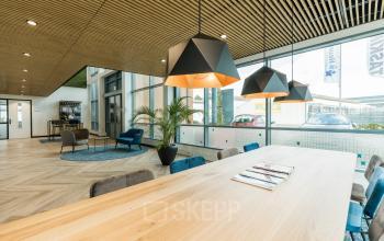 Kantoorruimte huren met moderne inrichting op Spoetnik 10-64, Amersfoort Calveen. Houten plafond, stijlvolle lampen en zithoek met grote ramen zorgen voor een lichte en open sfeer.