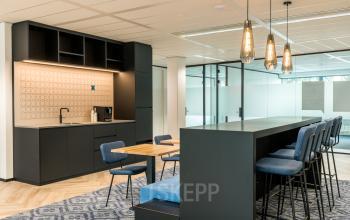 Moderne kantoorruimte met glazen wanden op Spoetnik 10-64, Amersfoort Calveen. Voorzien van stijlvolle verlichting, een lunchruimte met hoge stoelen en een kitchenette. Geschikt om kantoor te huren.