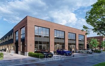 Kantoorpand Spaceshuttle 18C in Amersfoort Calveen met een moderne bakstenen gevel en parkeerplaatsen aan de voorkant. Verschillende auto's geparkeerd. Ideaal om kantoorruimte te huren.