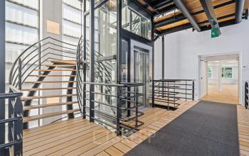 Moderne kantoorruimte op Maanlander 43 in Amersfoort Calveen met glazen lift en stijlvolle trap. Ideaal voor bedrijven die kantoorruimte willen huren in een uitnodigend kantoorpand.