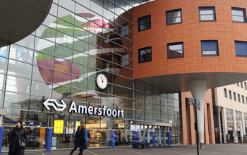 Buitenkant van het moderne kantoorpand op Stationsplein 49, onderdeel van Amersfoort Centraal Station, met opvallende architectuur en een grote glazen gevel.