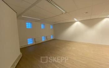 Lege kantoorruimte met houten vloer en witte muren op Van Asch van Wijckstraat 2-4, Amersfoort Centrum, ideaal voor huur.