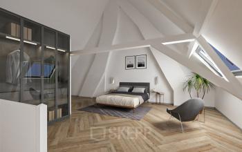 Lichte kamer met een bed, moderne stoel en planten in een zolderruimte van het kantoorpand op Stadsring 248-250, ideaal voor kantoorruimte huren in Amersfoort Centrum.
