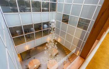 Kantoorruimte huren aan Kerkstraat 204 in Amsterdam Centrum met moderne, lichte inrichting en unieke glazen wanden in een open vloerplan. Ideaal voor creatieve professionals.