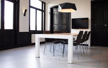 Meeting room with table and chairs black door