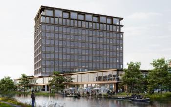 Buitenkant van modern kantoorpand aan de Rijnsburgstraat 9-11, Amsterdam De Schinkel, met grote ramen en omgeving met water en groen.