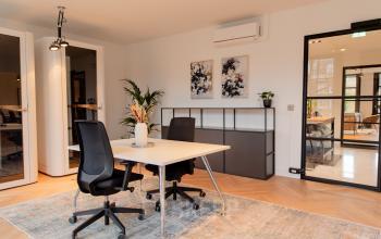 Moderne kantoorruimte huren aan Keizersgracht 121 in Amsterdam Grachtengordel met strak interieur, bureaus en kunst aan de muur.