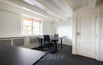 Kantoorruimte huren in een licht kantoorpand op Keizersgracht 452, Amsterdam Grachtengordel. Ruimte met strakke inrichting, bureaus, stoelen en grote ramen voor optimaal daglicht.