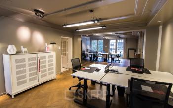 Gemeubileerd kantoor op Herengracht 280 in Amsterdam Grachtengordel met bureaus en stoelen, ideaal voor kantoorruimte huren.