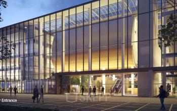 Modern kantoorpand met glazen gevel op Jacob Bontiusplaats 9, Amsterdam Oost. Mensen lopen en staan bij de ingang van het gebouw.