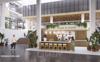 Binnenkant van kantoorpand op Jacob Bontiusplaats 9, Amsterdam Oost, met een moderne lobby en een café waar mensen werken en koffie halen.