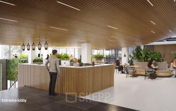 Modern kantoorpand op Jacob Bontiusplaats 9 in Amsterdam Oost, met houten plafonds, planten en enkele mensen die aan tafels werken en overleggen.