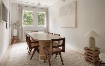 Verfijnde en lichte kantoorruimte te huur aan de Emmalaan 7-9 in Amsterdam Oud Zuid, met een stijlvolle houten tafel en stoelen, grote ramen en moderne decoraties.