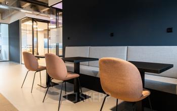 Moderne kantoorruimte huren in Amsterdam Sloterdijk met stijlvolle zitgedeelte en donkerblauwe accenten.