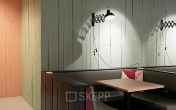 Moderne kantoorruimte in kantoorpand aan Hogehilweg 19, Amsterdam Zuid-Oost, met gezellige zithoek en artistieke verlichting.