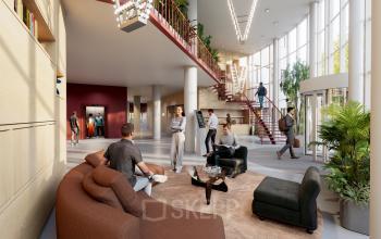 Lichte en moderne kantoorruimte op Luttenbergweg 8 in Amsterdam Zuid-Oost, met comfortabele zitplaatsen en mensen die zakelijke gesprekken voeren of de trap gebruiken.