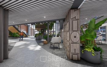 Moderne entree van kantoorpand op Jachthavenweg 109-A, Amsterdam Zuidas met groen decor en houten design meubels.