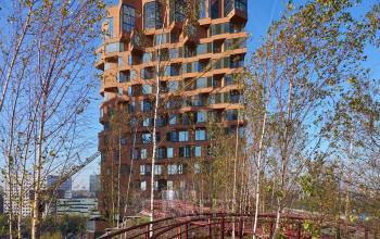 Exterieur van een kantoorpand aan de Hildegard Von Bingenstraat 44 in Amsterdam Zuidas, omringd door bomen en een kronkelend pad. Perfect voor kantoorruimte huren in een groene omgeving.