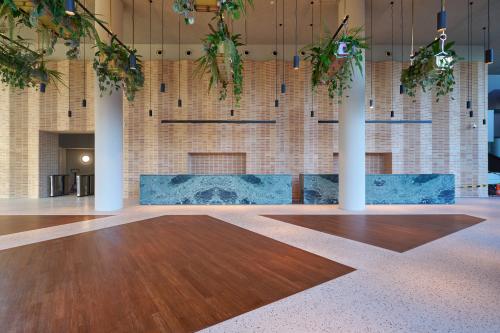 Modern ingerichte entree in een kantoorpand op Hildegard Von Bingenstraat 44, Amsterdam Zuidas, met natuurlijke elementen en strakke lijnen. Ideaal voor bedrijven die kantoorruimte willen huren op een toplocatie.