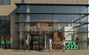 Buitenzijde van een kantoorpand op Barbara Strozzilaan 101 101 in Amsterdam Zuidas met een glazen entree waar mensen binnenkomen en bladeren. Ideale locatie om kantoorruimte te huren.