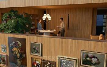 Kantoor in Amsterdam Zuidas met houten interieur, grote plant en schilderijen aan de muur. Twee mensen in gesprek aan een ronde tafel.