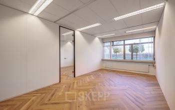 Lichte kantoorruimte te huur aan de Oude Apeldoornseweg 41-45 in Apeldoorn, met houten vloer en grote ramen voor natuurlijk licht. Ideaal voor je nieuwe kantoorpand.
