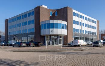 Buitenzijde van een modern kantoorpand aan de Kamerlingh Onnesweg 10 in Barendrecht met parkeerplaatsen aan de voorkant. Geschikt voor kantoorruimte huren.