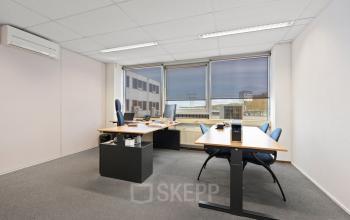 Kantoorruimte te huur op de Kamerlingh Onnesweg 10 in Barendrecht met twee bureaus, stoelen en veel natuurlijk lichtinval. Ideaal voor een productieve werkomgeving.