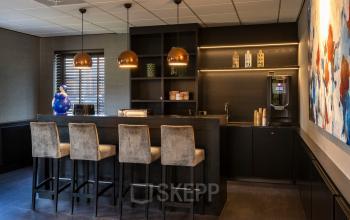 Kantoorruimte huren met stijlvolle baropstelling op Takkebijster 57A in Breda Oost-Brabantpark, voorzien van hoge stoelen en moderne verlichting.