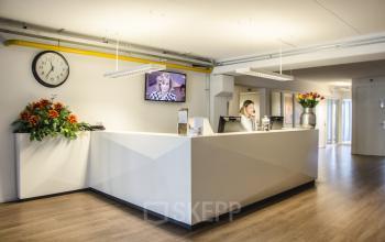 receptie balie bemand vrouw scherm klok