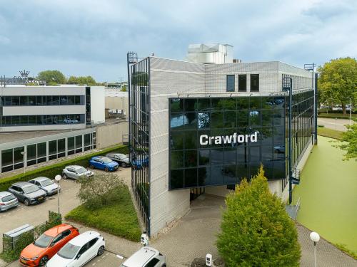 Modern kantoorpand aan Vlierbaan 20 in Capelle aan den IJssel met ruime parkeerplaats en groene omgeving. Voorzien van een glazen gevel en omgeven door groen.