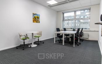 Kantoorruimte huren in Den Bosch op Pettelaarpark 84 met twee bureaus, stoelen en een tafel, ideaal voor kleine teams. Grote ramen zorgen voor natuurlijk licht in het kantoorpand.