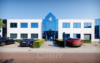 Voorkant van kantoorpand op Europalaan 4, Den Bosch met opvallende blauwe gevel en parkeerplaatsen. Perfecte locatie voor kantoorruimte huren.