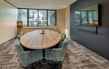 Vergaderruimte in kantoorpand Europalaan 4, Den Bosch, voorzien van een ovale tafel met stoelen en moderne inrichting.