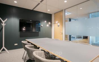 Vergaderruimte in kantoorpand aan Alexanderveld 5-9, Den Haag Centrum, met moderne inrichting, comfortabel meubilair en strakke vergadertafel. Ideaal voor bedrijven die kantoorruimte huren in een professionele omgeving.