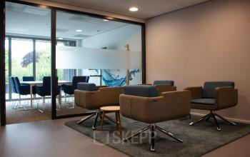 Moderne vergaderruimte bij kantoor op Hurksestraat 60 in Eindhoven De Hurk, ingericht met comfortabele stoelen en een vergadertafel, ideaal voor zakelijke bijeenkomsten.