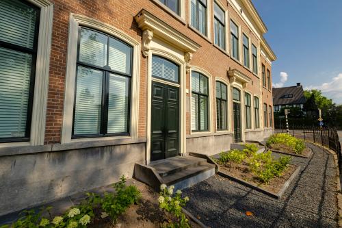 Buitenkant van een kantoorpand op Kennemerplein 20, Haarlem Centraal Station. Traditioneel met baksteen, grote ramen en een klassieke uitstraling. Kantoorruimte huren in deze locatie biedt charme en toegankelijkheid.