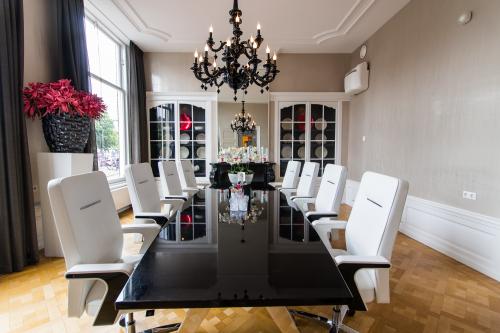 Elegant ingerichte vergaderruimte in kantoorpand aan Nieuwe Gracht 3, met grote tafel, luxe stoelen en stijlvol decor