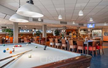 Ruime en lichte werkruimte met een biljarttafel en diverse zitplekken, ideaal voor het huren van kantoorruimte. Moderne uitstraling in het kantoorpand op A. Hofmanweg 5A, Haarlem Waarderpolder.