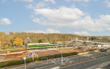 Uitzicht vanuit het kantoor op Haarlemmerstraatweg 13A, Halfweg, met zicht op treinstation en omliggende wegen.