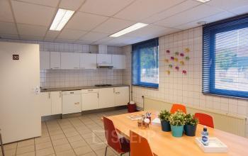 canteen pantry small kitchen tabel and coloured chairs