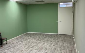 Leeg kantoorpand aan de Hamerstraat 10 in Hengelo met groene muren en grijze houten vloer, geschikt voor kantoorruimte huren.