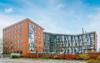 Buitenzijde van het kantoorpand op Siriusdreef 16 in Hoofddorp, met moderne architectuur en ruime parkeerplaats. Geschikt voor kantoorruimte huren in een levendige omgeving.