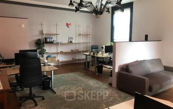 Kantoorruimte huren op Schiekade 105, Rotterdam Centrum: modern ingerichte werkruimte met bureaus, stoelen en een zitbank.