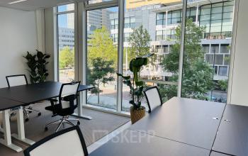 Moderne kantoorruimte op Kruisplein 480, Rotterdam Centrum, met grote ramen en uitzicht. De ruimte is ingericht met bureaus en stoelen, ideaal voor wie kantoorruimte wilt huren.