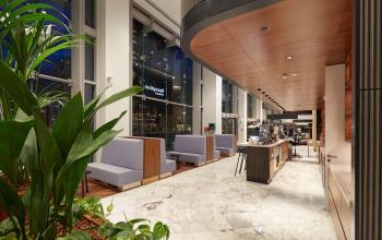 Moderne kantoorruimte op Blaak 555, Rotterdam Centrum met stijlvolle inrichting, marmeren vloeren, houten details en enkele planten. Ruim opgezet voor een ontspannen werkomgeving.