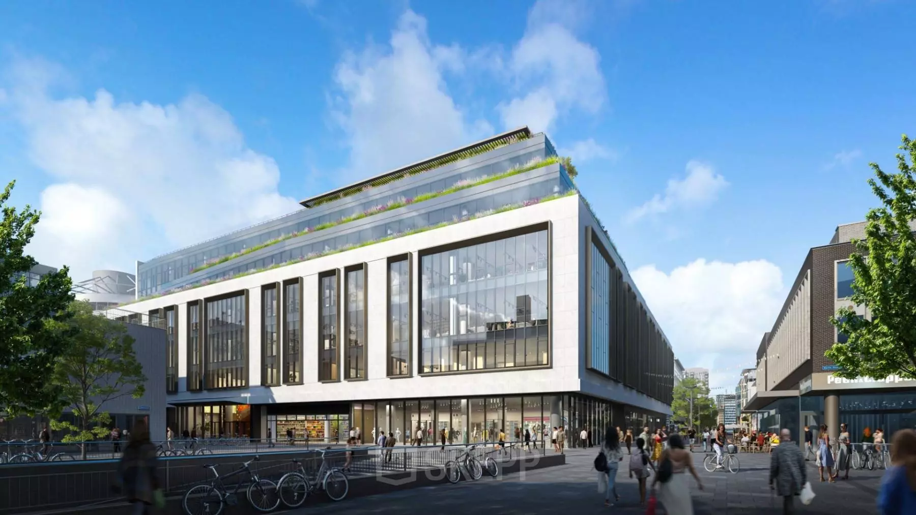 Modern kantoorpand op Hoogstraat 185 in Rotterdam Centrum, met fietsenstalling en enkele mensen buiten het gebouw.