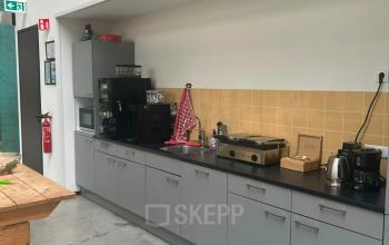 Een strak ingerichte pantry bij een kantoorpand op Scheepsbouwweg 29, Rotterdam Waalhaven. Deze kantoorruimte huren biedt moderne voorzieningen met een keurige koffiemachine en aanrecht. Ideaal voor ontspannen pauzes tijdens je werkdag.