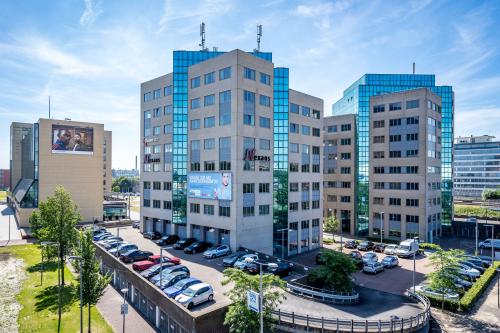 Exterieur van het kantoorpand aan Overschieseweg 304-332, Schiedam, met meerdere moderne gebouwen en parkeerplaatsen. Ideaal voor kantoorruimte huren.